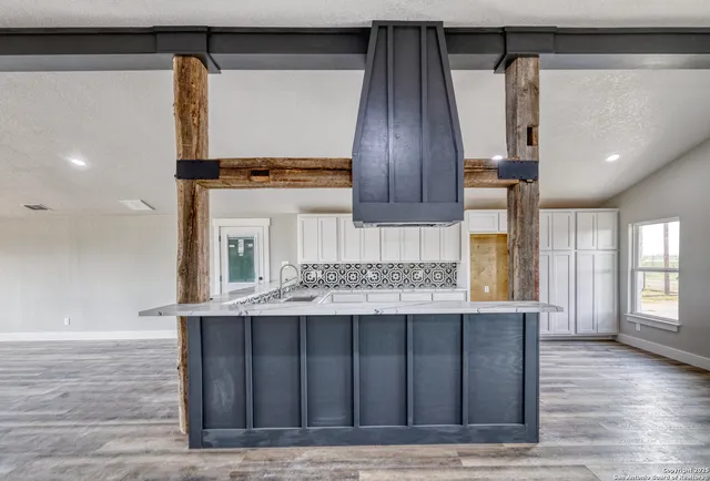 a kitchen with a sink cabinets and wooden floor