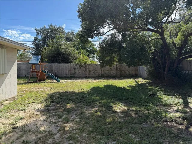 a view of a backyard with a garden and trees