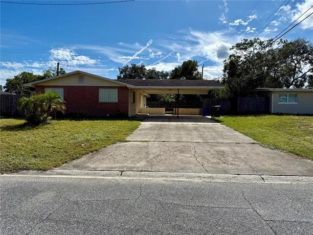 a view of house with yard and green space