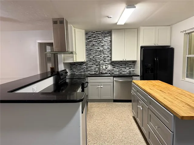 a kitchen with a sink stove and refrigerator