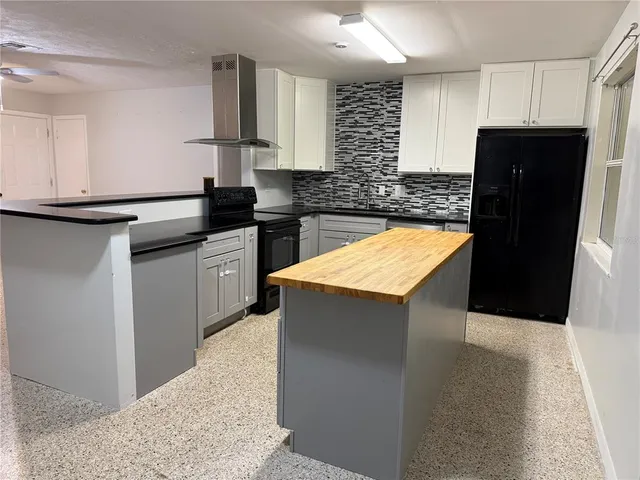 a kitchen with stainless steel appliances granite countertop refrigerator sink and cabinets
