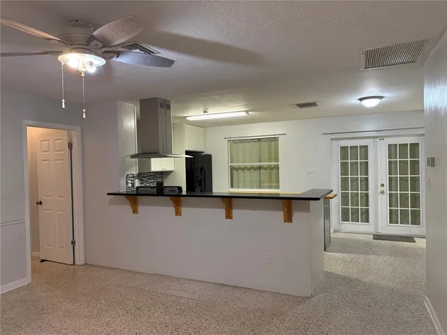 a view of kitchen with stainless steel appliances refrigerator stove and microwave