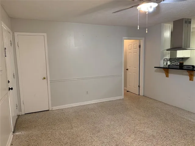 an empty room with a kitchen