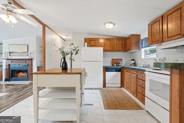 a kitchen with stainless steel appliances granite countertop a refrigerator and a stove top oven