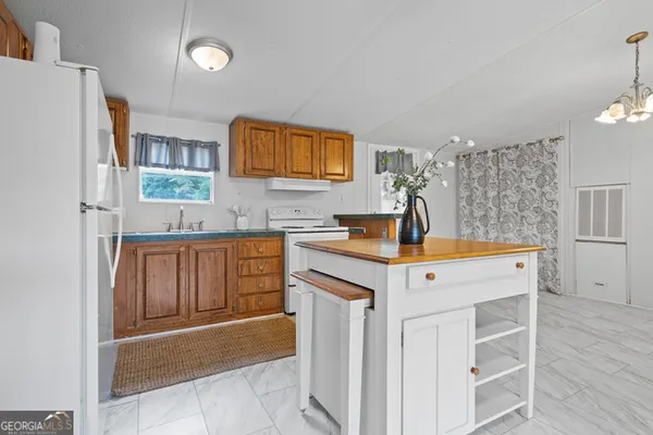 a kitchen with a sink cabinets and wooden floor