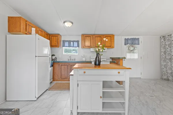 a kitchen with stainless steel appliances a refrigerator and a sink