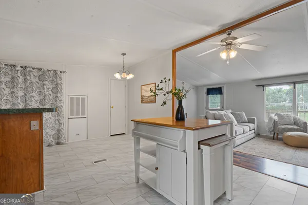 a view of kitchen with kitchen island stainless steel appliances sink stove and refrigerator