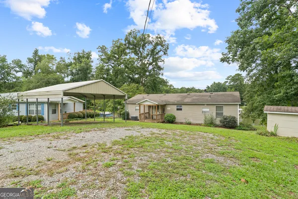 a big house with a big yard and large trees