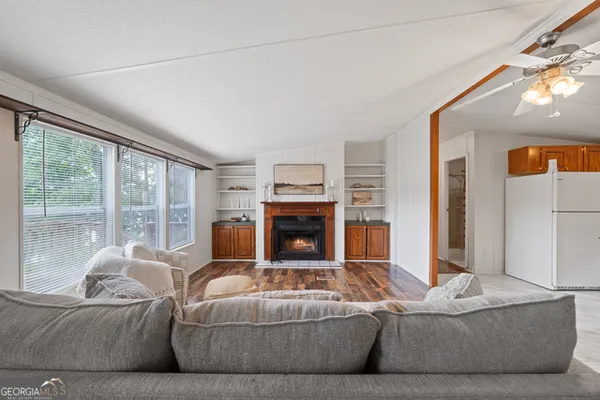 a living room with furniture and a fireplace