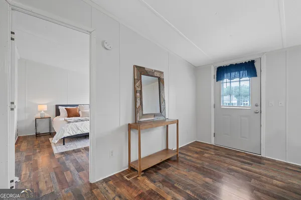 a view of an empty room and wooden floor