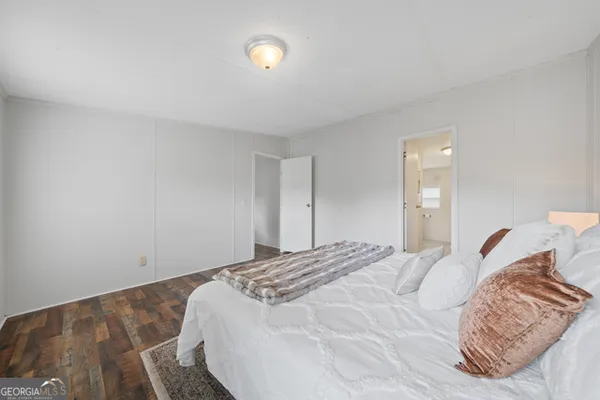 a bedroom with a bed and a mirror