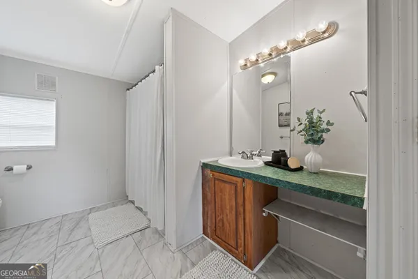 a bathroom with a sink and a mirror