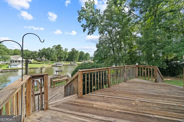 a view of balcony with wooden floor and lake view