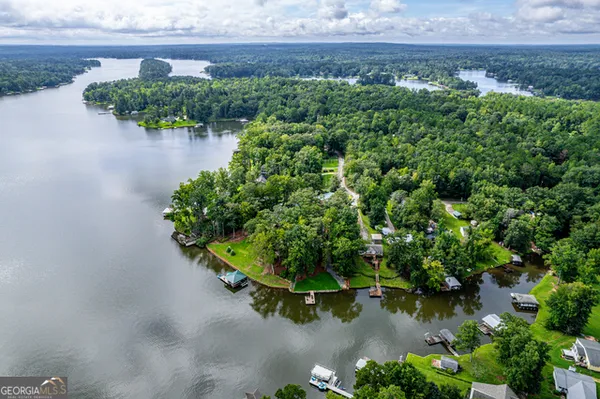 an aerial view of a house with a yard basket ball court and outdoor seating