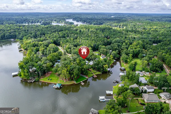 swimming pool view with a garden and trees