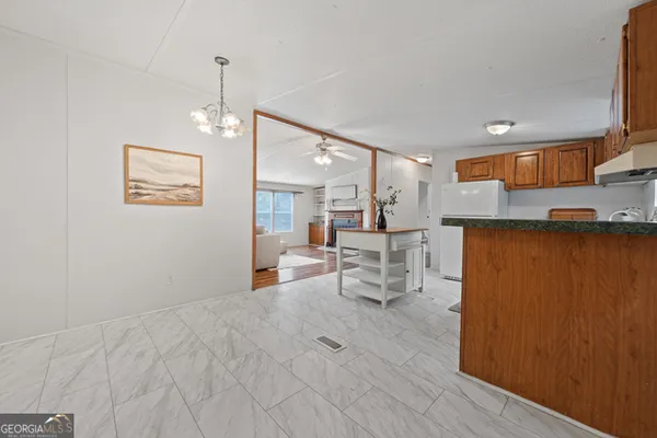 a view of a kitchen with dining room and wooden floor
