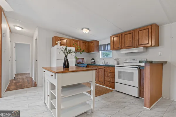 a kitchen with a sink cabinets and window