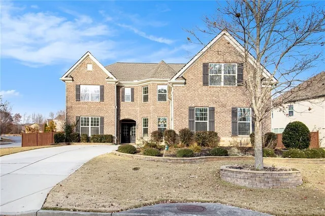 a front view of a house with a yard