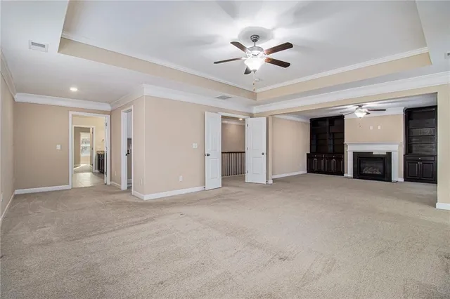 a view of a livingroom with a fireplace and a ceiling fan