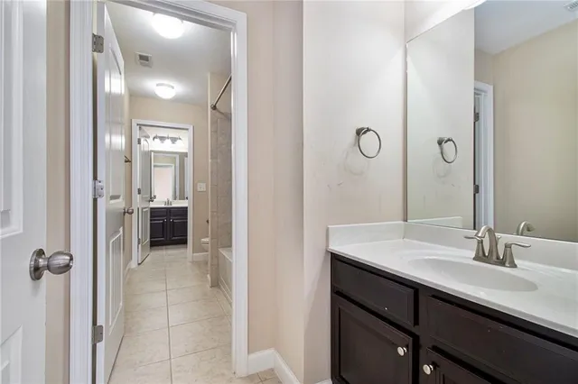 a view of an empty room and a ceiling fan