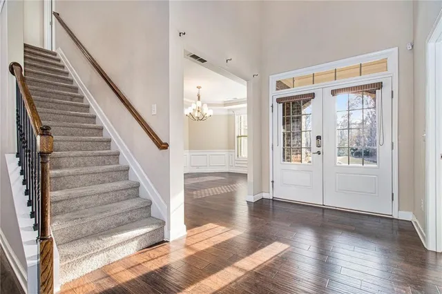 a view of entryway and hall with wooden floor
