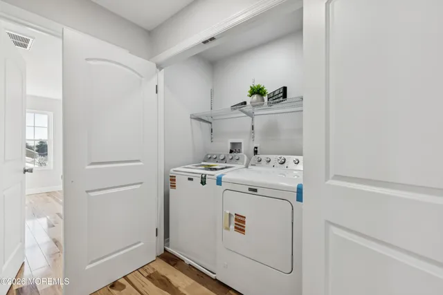 a kitchen with stainless steel appliances granite countertop a sink a counter top space cabinets and wooden floor