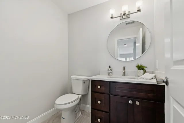 a view of empty room with wooden floor and window