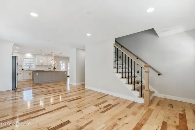 a kitchen with granite countertop white cabinets and stainless steel appliances