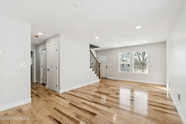 a kitchen with refrigerator cabinets and wooden floor