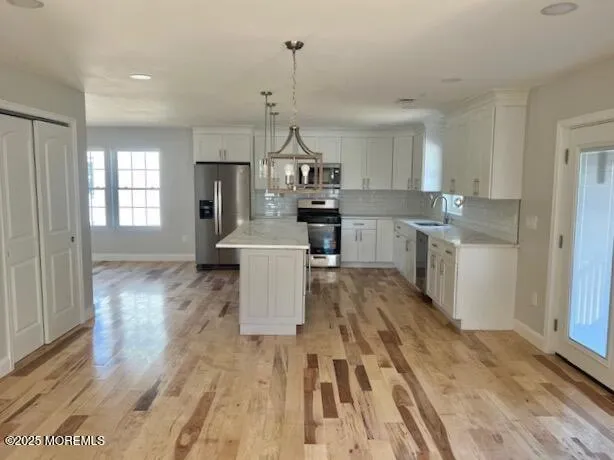 a living room with kitchen island furniture and a wooden floor