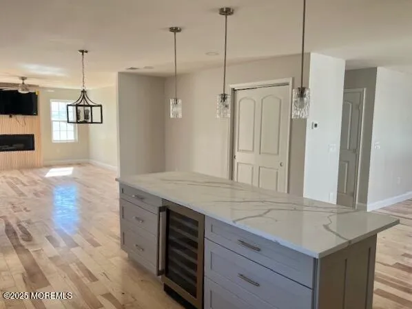 a kitchen with stainless steel appliances granite countertop a sink a counter top space cabinets and wooden floor