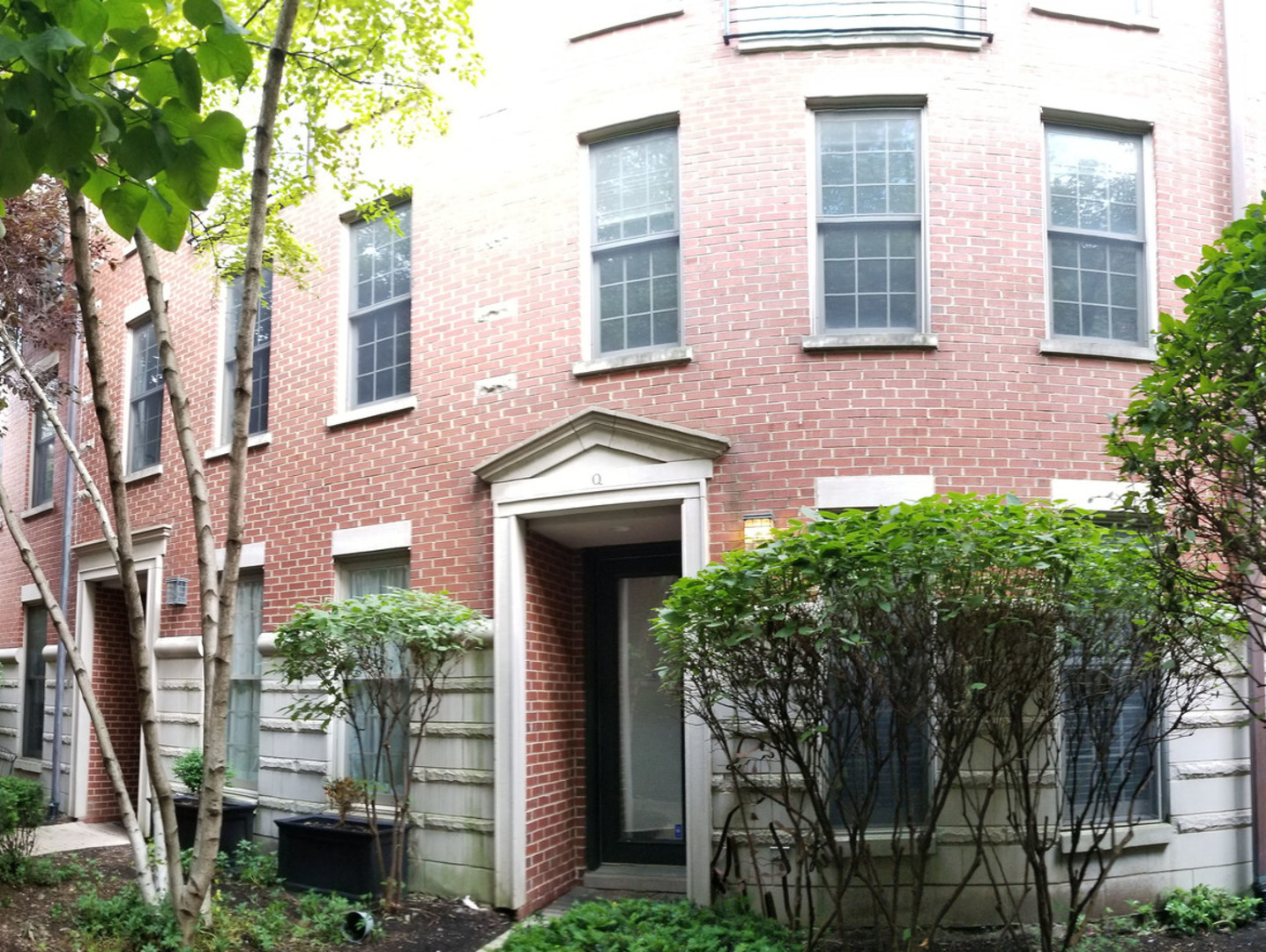 1229 West Madison Street, Unit Q Chicago, IL 60607 - Photo 1 of 32 a front view of a house with plants