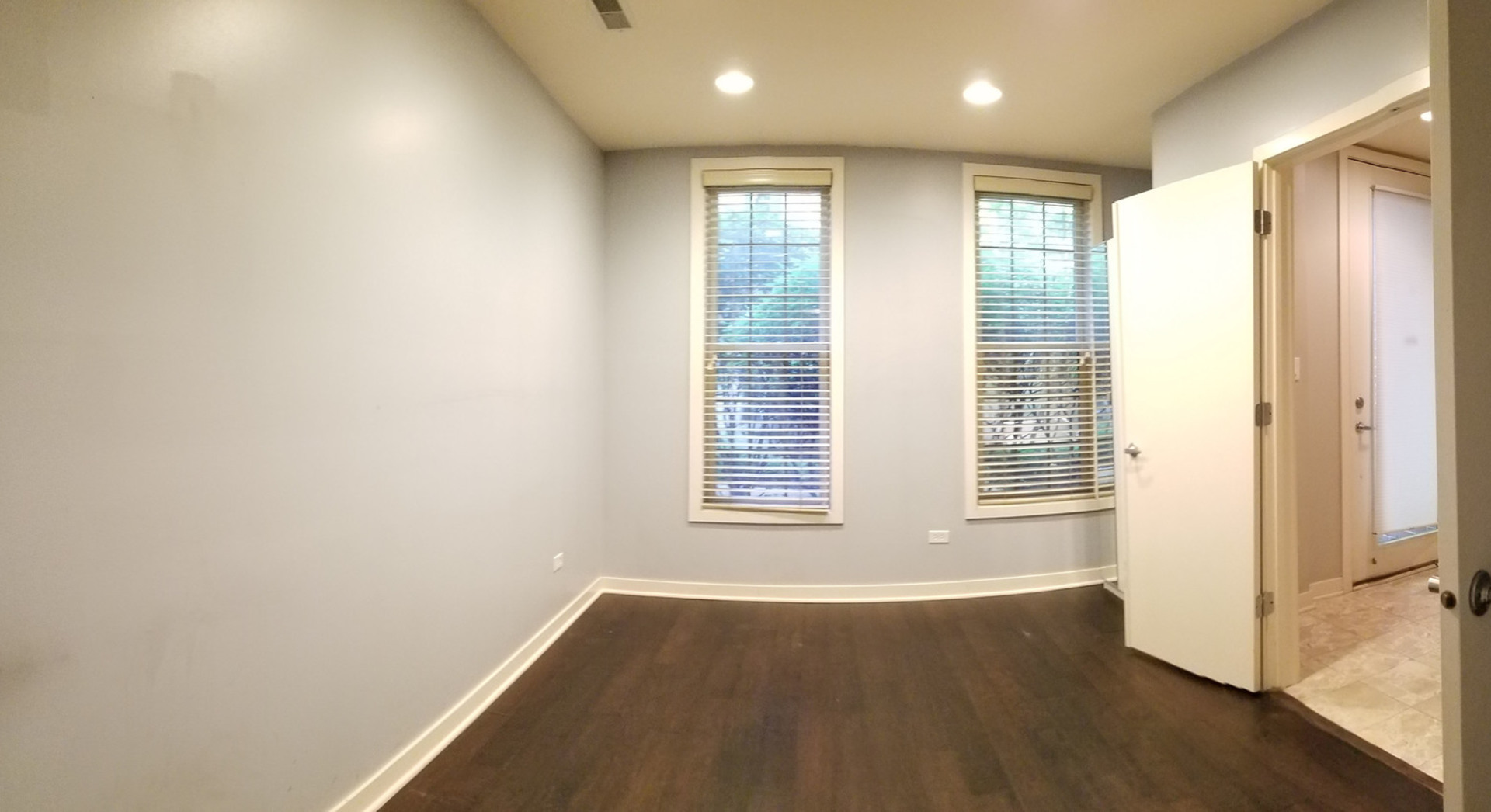1229 West Madison Street, Unit Q Chicago, IL 60607 - Photo 11 of 32 an empty room with wooden floor and windows