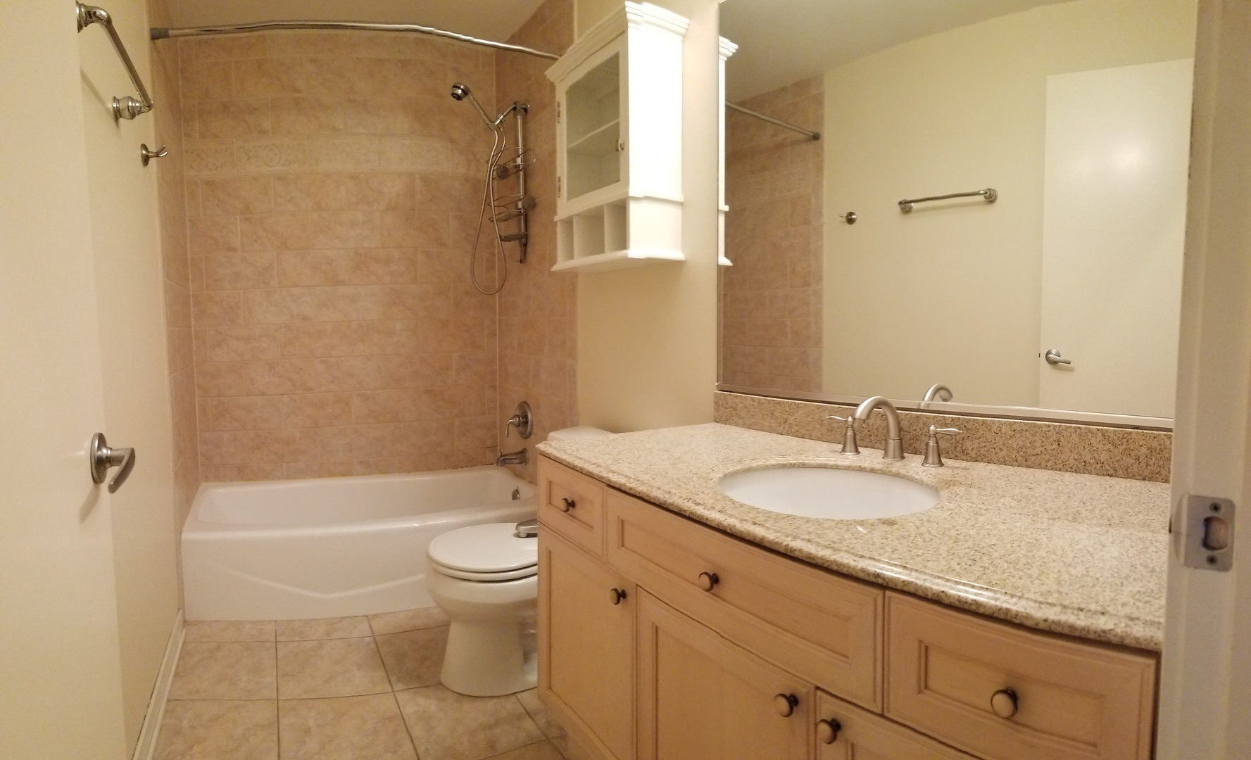 1229 West Madison Street, Unit Q Chicago, IL 60607 - Photo 20 of 32 a bathroom with a granite countertop sink a toilet and shower