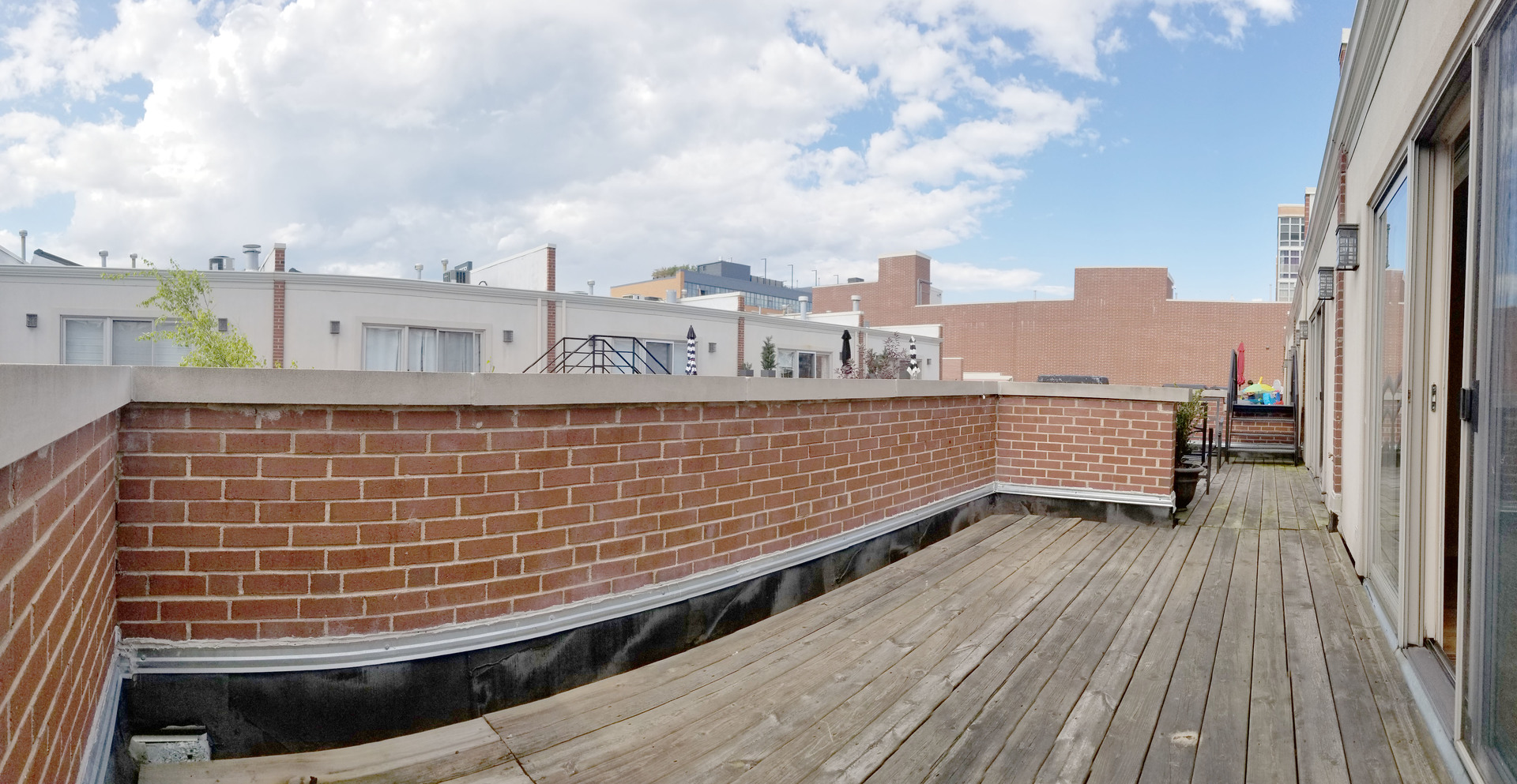 1229 West Madison Street, Unit Q Chicago, IL 60607 - Photo 31 of 32 a view of a balcony with wooden floor and city view
