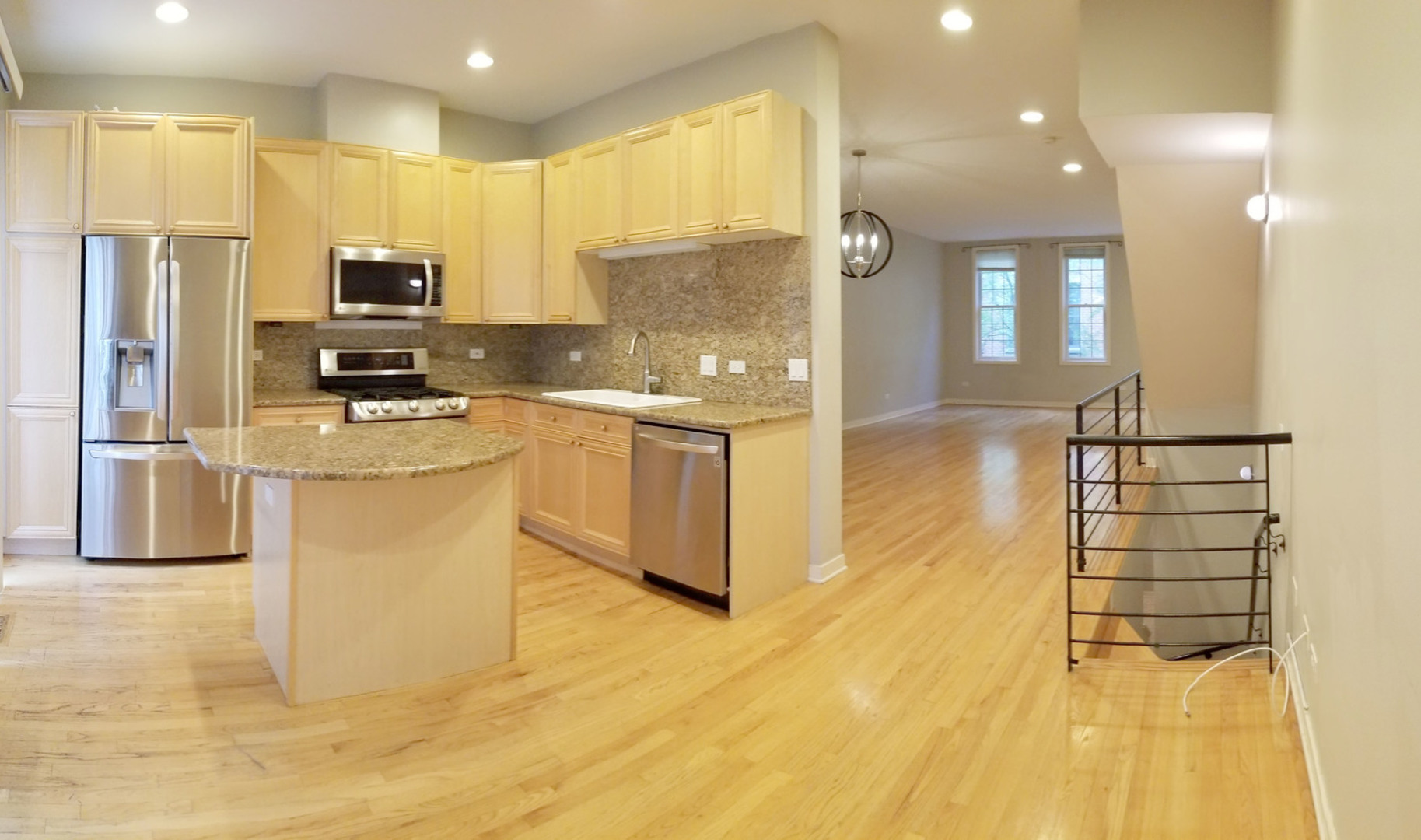 1229 West Madison Street, Unit Q Chicago, IL 60607 - Photo 4 of 32 a kitchen with stainless steel appliances granite countertop a sink refrigerator and cabinets