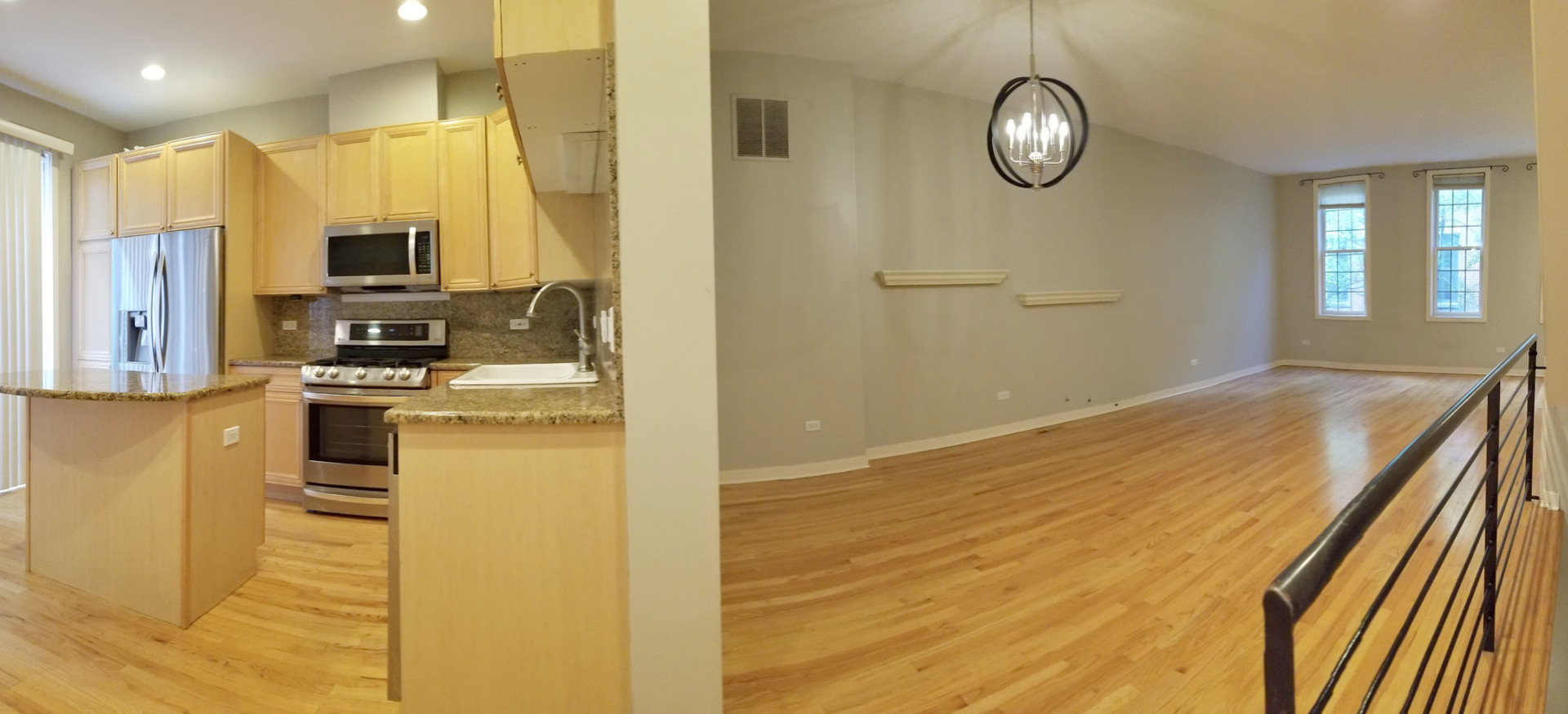 1229 West Madison Street, Unit Q Chicago, IL 60607 - Photo 5 of 32 a kitchen with stainless steel appliances kitchen island granite countertop a refrigerator and stove