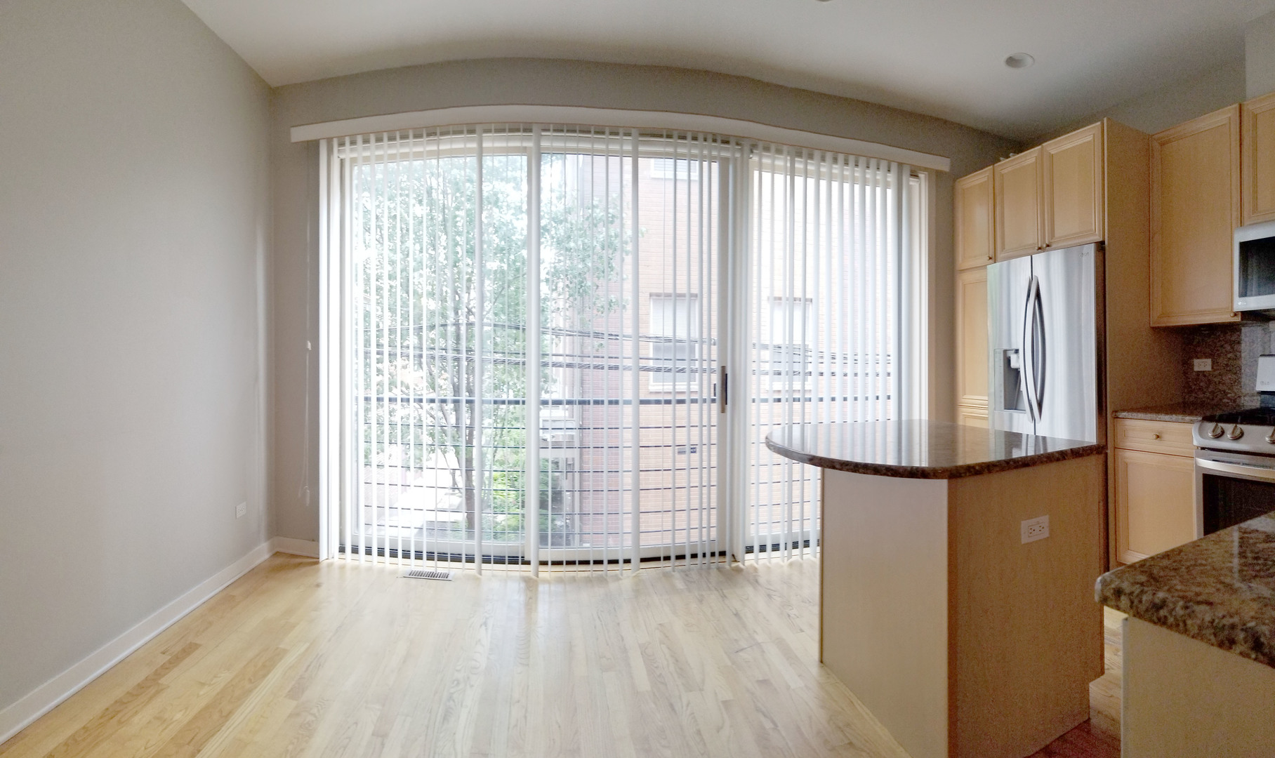 1229 West Madison Street, Unit Q Chicago, IL 60607 - Photo 9 of 32 a view of kitchen with wooden floor and electronic appliances