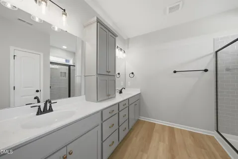 a bathroom with a double vanity sink and mirror