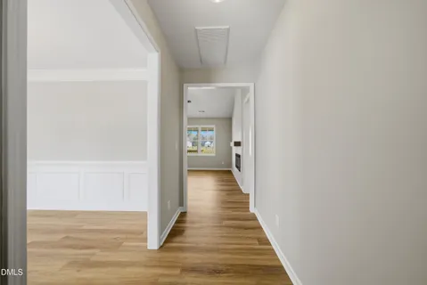 a view of a hallway with wooden floor