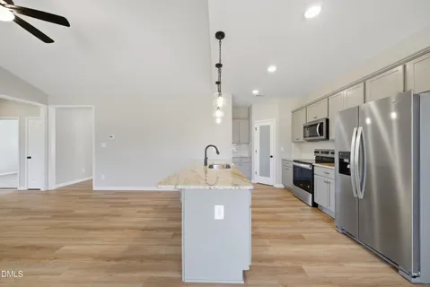 a kitchen with stainless steel appliances a refrigerator sink and stove