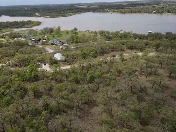an aerial view of a houses with a forest