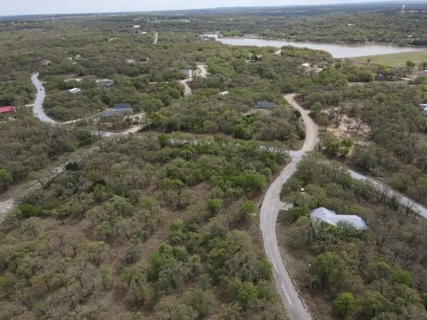 a view of a lake with trees in front of house
