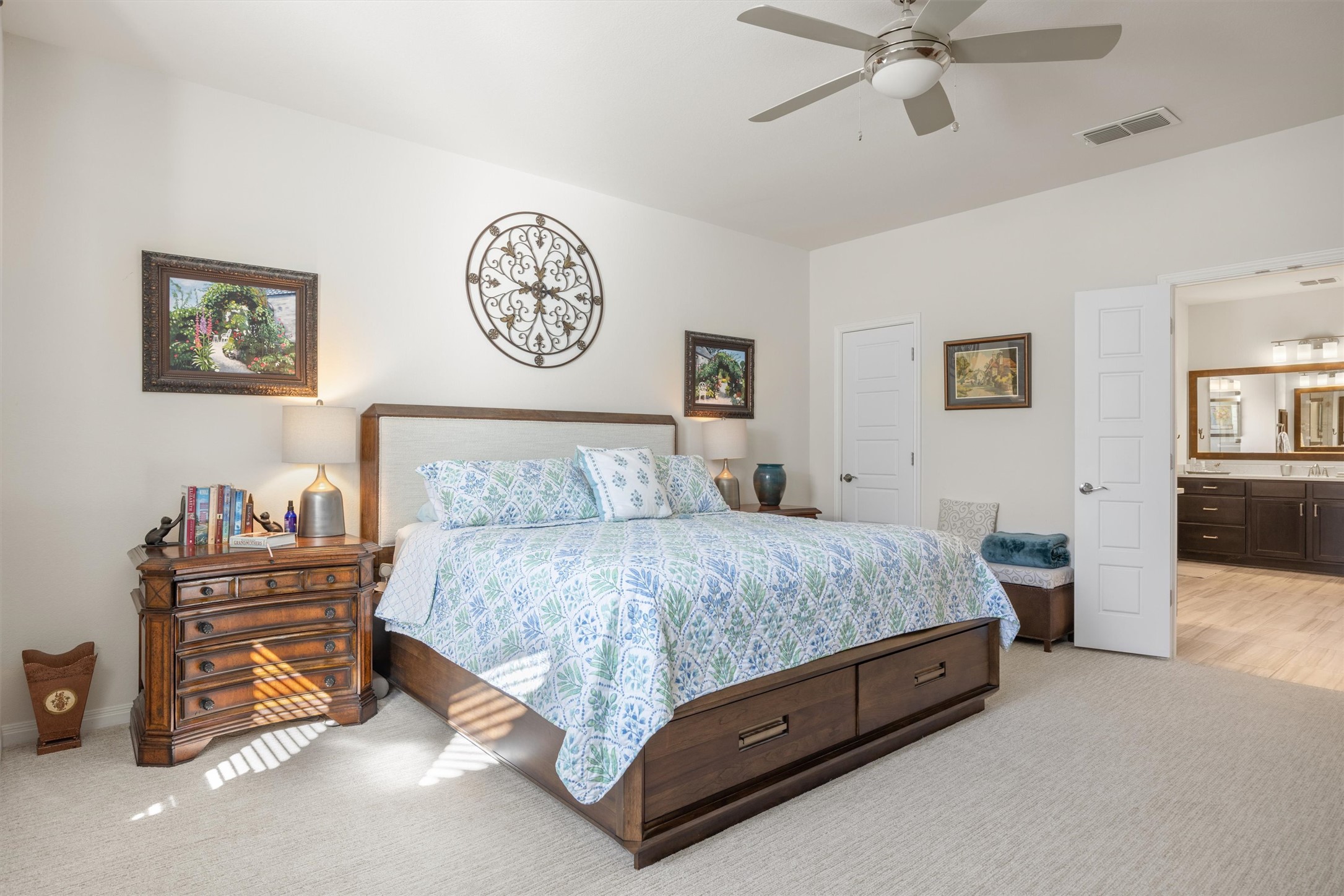 210 Raptor Beak Way Cedar Creek, TX 78612 - Photo 13 of 36 a spacious bedroom with a bed and a chandelier