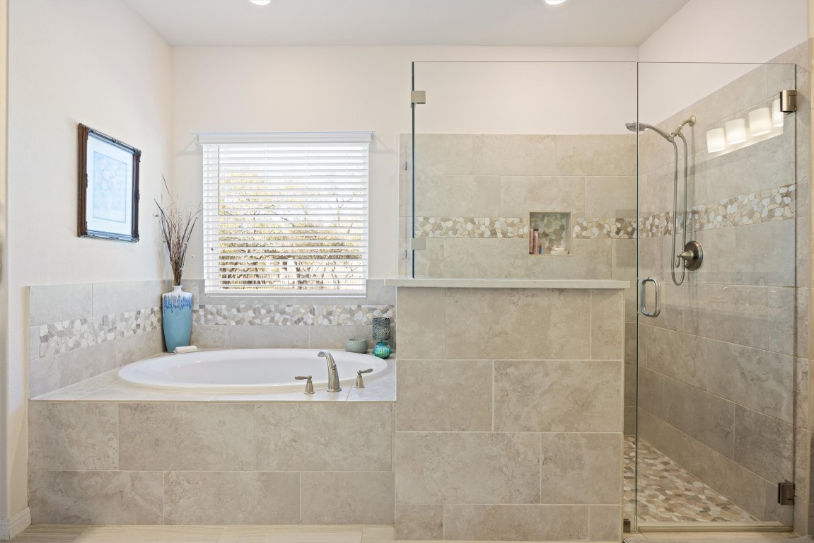 210 Raptor Beak Way Cedar Creek, TX 78612 - Photo 15 of 36 a bathroom with a bathtub and shower