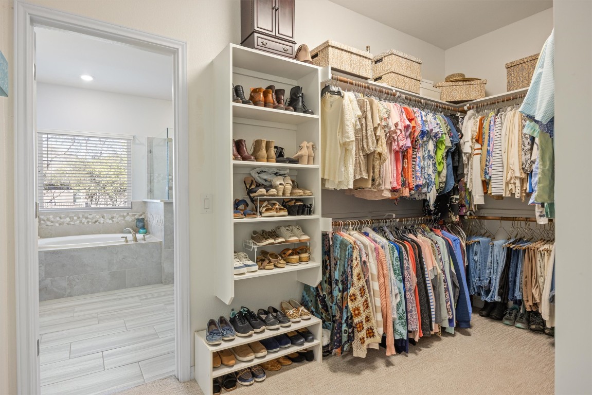 210 Raptor Beak Way Cedar Creek, TX 78612 - Photo 16 of 36 a view of walk in closet with clothes and shoes