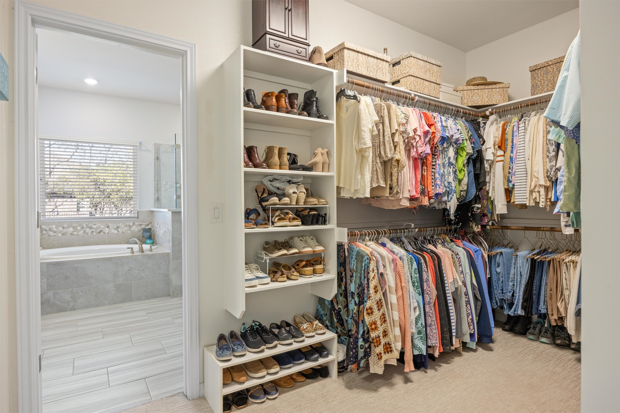 210 Raptor Beak Way Cedar Creek, TX 78612 - Photo 17 of 36 a view of walk in closet with clothes and shoes