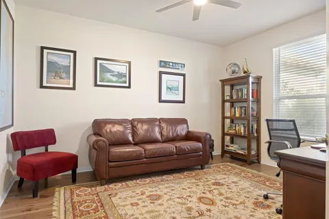 a view of a workspace with furniture and a window