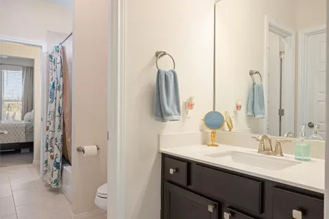 a bathroom with a shower curtain and a sink