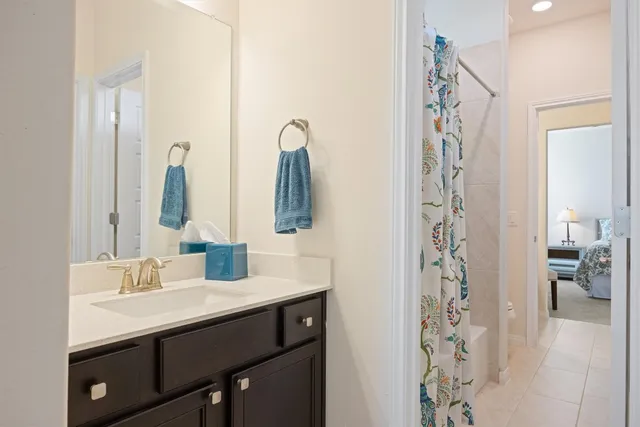 a bathroom with a double vanity sink mirror and shower